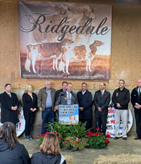 speakers at a podium supporting whole milk