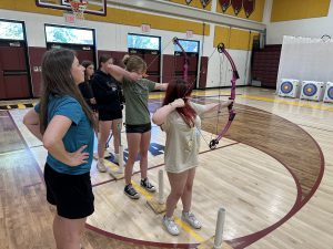 BKW Health and Physical Education teacher Ms. Gorman teaching students proper technique in their recent archery class.
