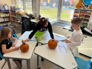 Students in Mrs. Thurber’s and Ms. Mundell’s first-grade class brought a pie-sized pumpkin to school for the Pumpkin Observation Scienceevent.