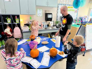 First-grade students did it all throughout the pumpkin observation. From measuring a pumpkin's circumference and height to weighing it, journaling their findings for future reference, and learning about its nutritional value.