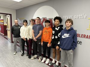 Mr. Morin (far left) posing with a number of his Sports Analytics students. The course utilizes a variety of topics, strategies, and calculations found in core statistics courses but brings in how teams or players are evaluated in the course of a career or how they are predicted to perform in future seasons.