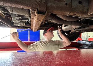 Berne-Knox-Westerlo High School senior Matthew Dibble works on the underside of an engine during a recent class at the Career and Technical Education Center – Schoharie Campus.